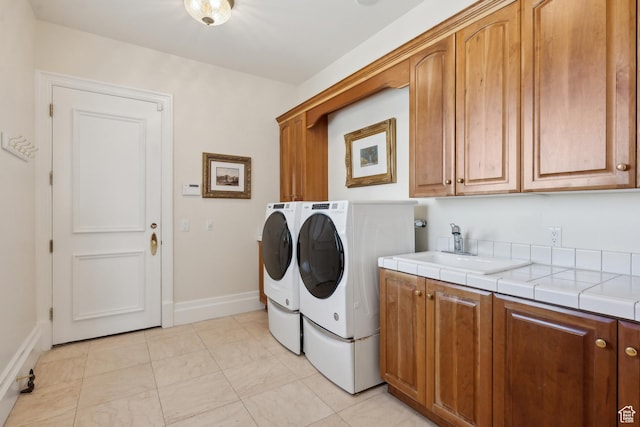 1714 Ridge Point Dr, Bountiful, UT 84010 - laundry room with baseboards, cabinet space, washer and clothes dryer, and a sink