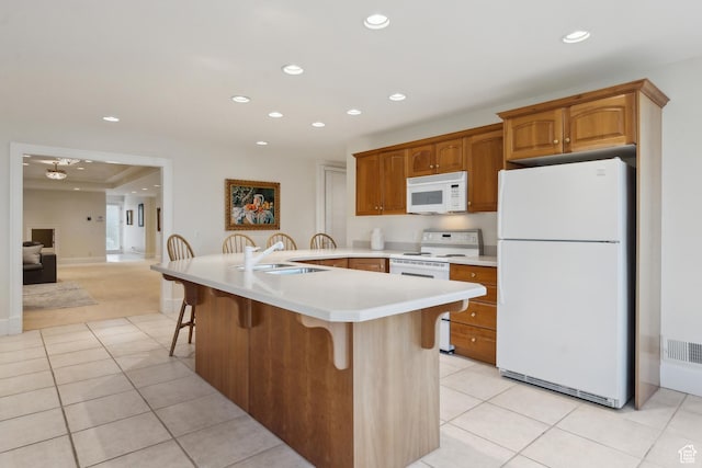 1714 Ridge Point Dr, Bountiful, UT 84010 - kitchen with a sink, light tile patterned flooring, a breakfast bar, visible vents, and white appliances