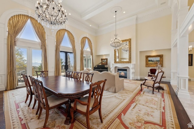 1714 Ridge Point Dr, Bountiful, UT 84010 - dining room featuring beamed ceiling, a glass covered fireplace, ornamental molding, a notable chandelier, and a high ceiling