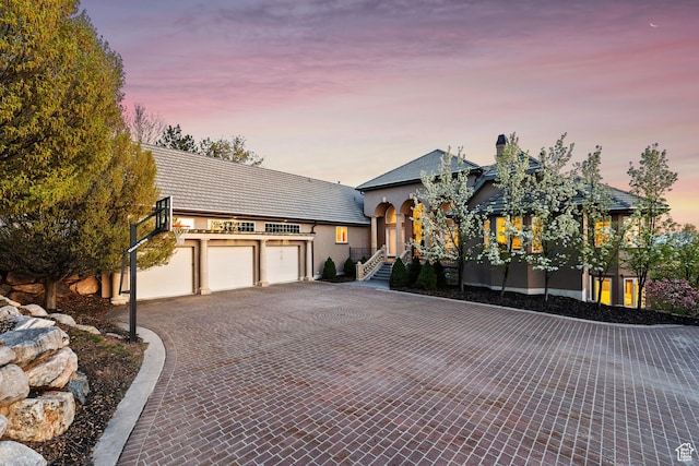 1714 Ridge Point Dr, Bountiful, UT 84010 - view of front of property featuring decorative driveway, a garage, stucco siding, and an outbuilding
