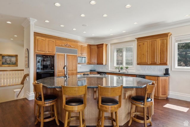 1714 Ridge Point Dr, Bountiful, UT 84010 - kitchen featuring a sink, paneled fridge, a center island with sink, dobule oven black, and plenty of natural light