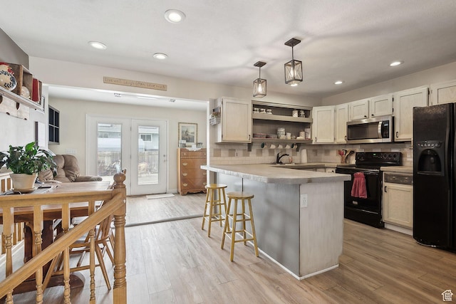 472 W 330 S, American Fork, UT 84003 - kitchen featuring decorative backsplash, open shelves, a breakfast bar, light countertops, and black appliances