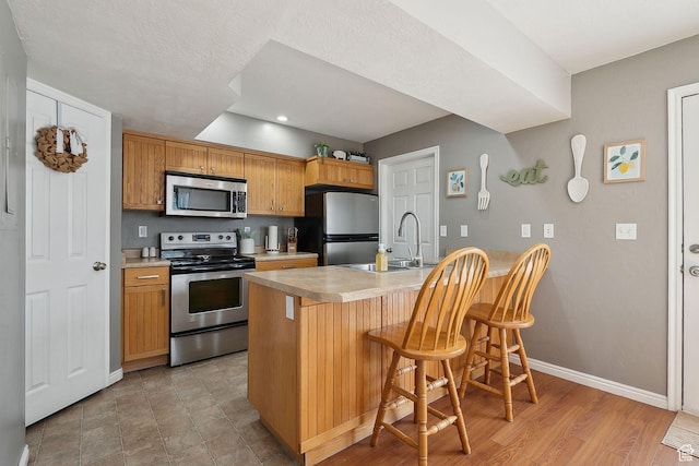 472 W 330 S, American Fork, UT 84003 - kitchen with a sink, stainless steel appliances, light countertops, and baseboards
