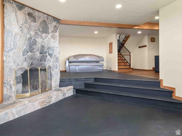 4120 S Beus Dr E, Ogden, UT 84403 - staircase with recessed lighting, a stone fireplace, and a textured ceiling