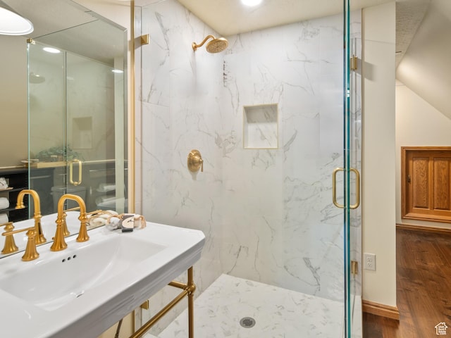 4120 S Beus Dr E, Ogden, UT 84403 - bathroom with a marble finish shower, a sink, and wood finished floors
