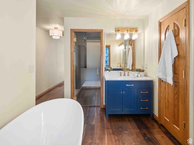 4120 S Beus Dr E, Ogden, UT 84403 - bathroom with a freestanding bath, wood finished floors, and vanity