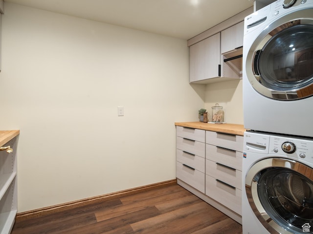 4120 S Beus Dr E, Ogden, UT 84403 - washroom featuring cabinet space, baseboards, stacked washing maching and dryer, and dark wood-style flooring