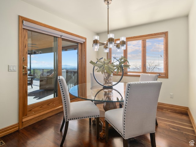 4120 S Beus Dr E, Ogden, UT 84403 - dining space with baseboards, wood finished floors, and an inviting chandelier