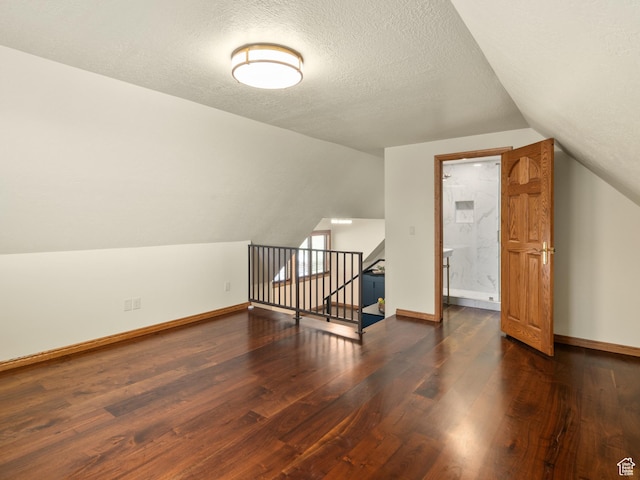 4120 S Beus Dr E, Ogden, UT 84403 - bonus room featuring baseboards, wood finished floors, a textured ceiling, and lofted ceiling
