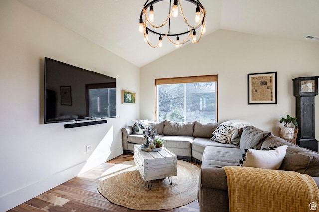 living area featuring an inviting chandelier, baseboards, wood finished floors, lofted ceiling, and visible vents