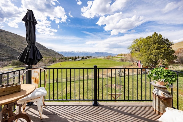 balcony featuring a mountain view and a rural view