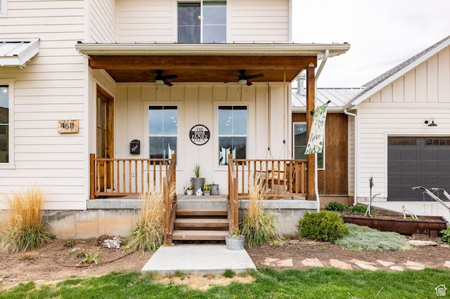 view of exterior entry featuring a ceiling fan, board and batten siding, an attached garage, and a porch