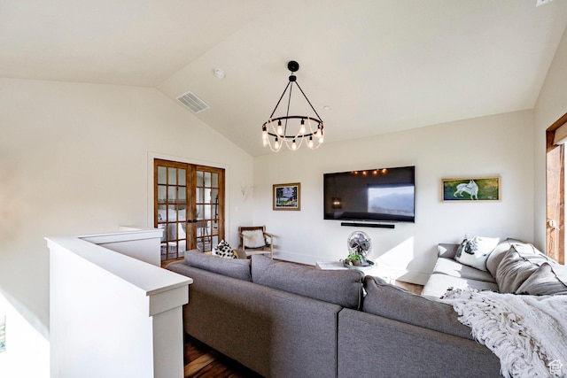 living room with visible vents, a chandelier, french doors, dark wood finished floors, and vaulted ceiling
