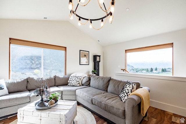 living room with vaulted ceiling, a notable chandelier, wood finished floors, and visible vents