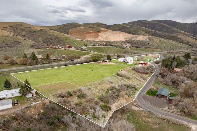 drone / aerial view featuring a mountain view and a rural view