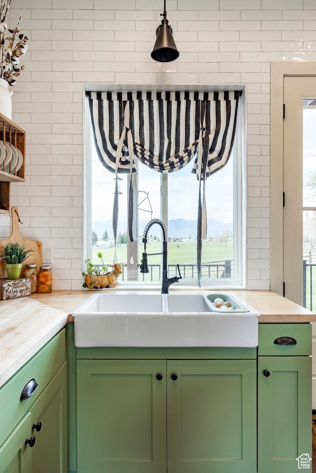 kitchen with a sink and green cabinetry