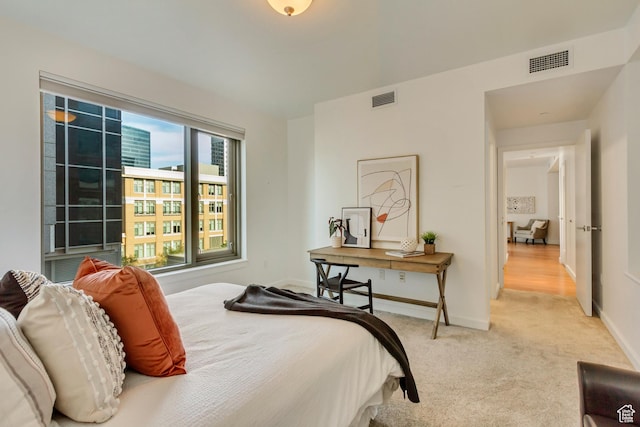 45 W S Temple St Unit 701, Salt Lake City, UT 84101 - bedroom with baseboards, visible vents, and light colored carpet