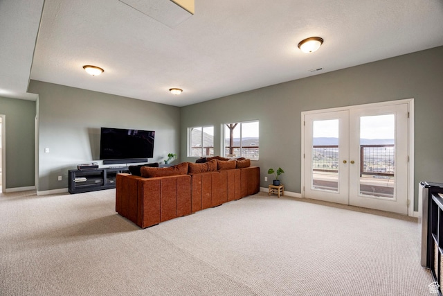 living area with french doors, light colored carpet, and baseboards