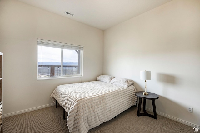 carpeted bedroom featuring baseboards and visible vents