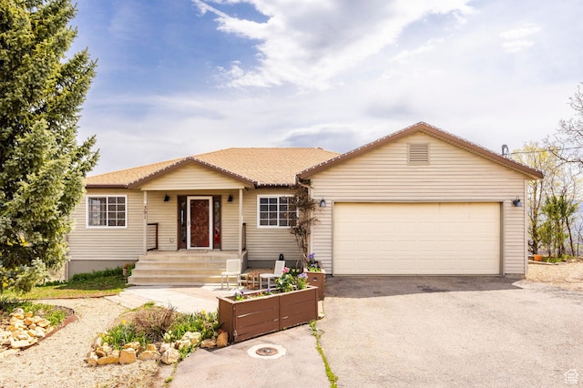 ranch-style house with a garage and aphalt driveway