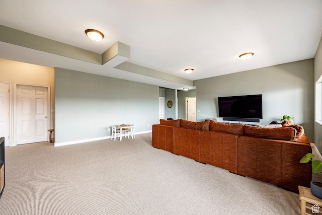carpeted living area with baseboards