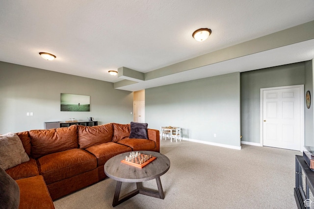 carpeted living area with baseboards