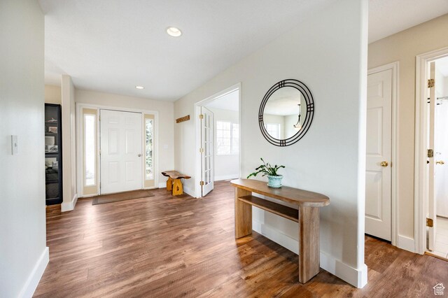 entryway with recessed lighting, wood finished floors, and baseboards