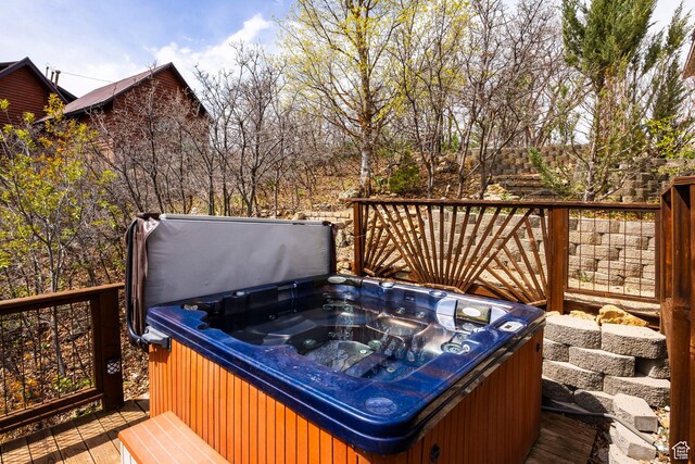 wooden deck with a hot tub
