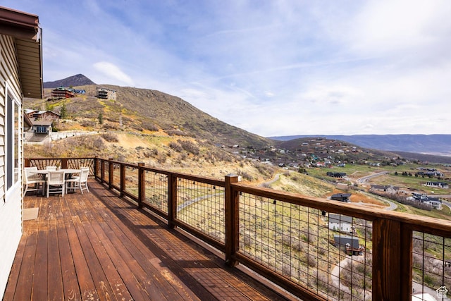 wooden deck featuring a mountain view and outdoor dining space