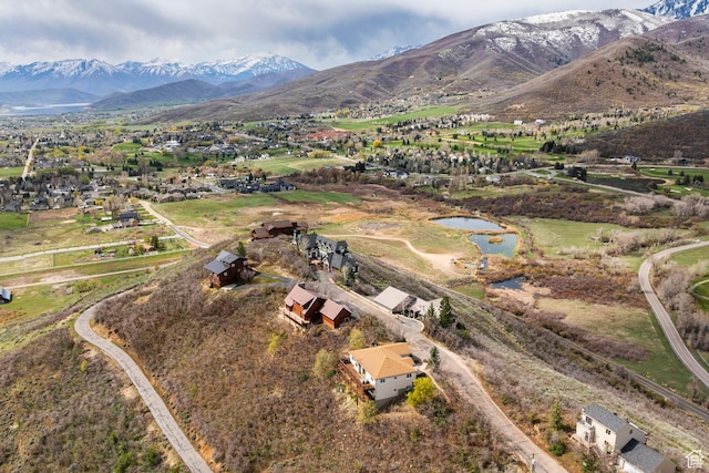 drone / aerial view featuring a water and mountain view