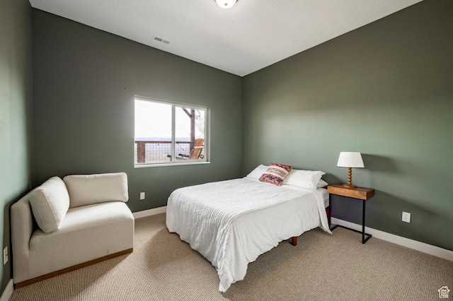 bedroom featuring baseboards, visible vents, and carpet floors