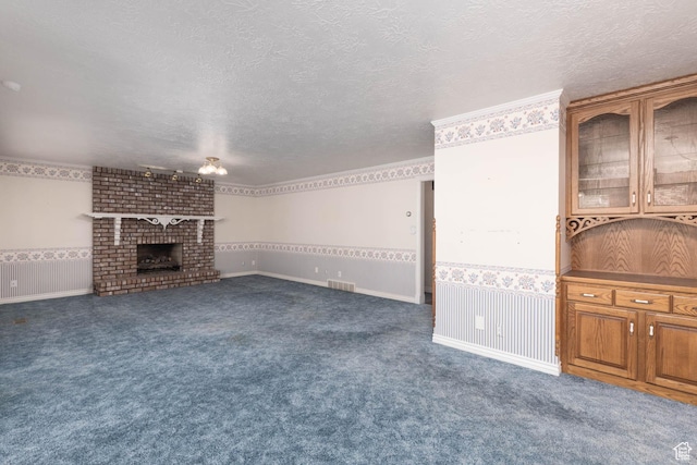 889 Upland Dr, Richfield, UT 84701 - unfurnished living room with a textured ceiling, visible vents, carpet flooring, and a brick fireplace