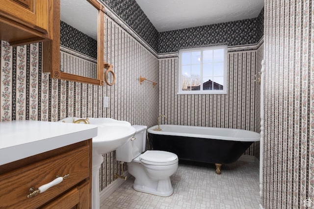 889 Upland Dr, Richfield, UT 84701 - bathroom with toilet, wallpapered walls, and a soaking tub