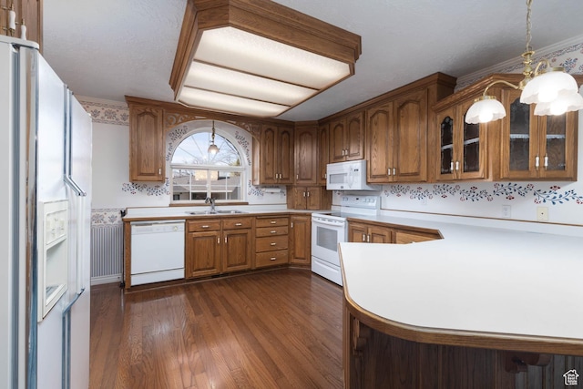 889 Upland Dr, Richfield, UT 84701 - kitchen featuring dark wood-style floors, light countertops, brown cabinets, and white appliances