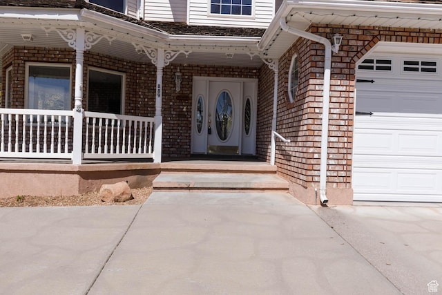 889 Upland Dr, Richfield, UT 84701 - view of exterior entry featuring a garage, covered porch, and brick siding