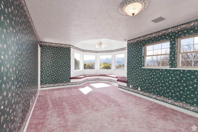 889 Upland Dr, Richfield, UT 84701 - carpeted spare room with a textured ceiling, visible vents, wallpapered walls, and baseboards