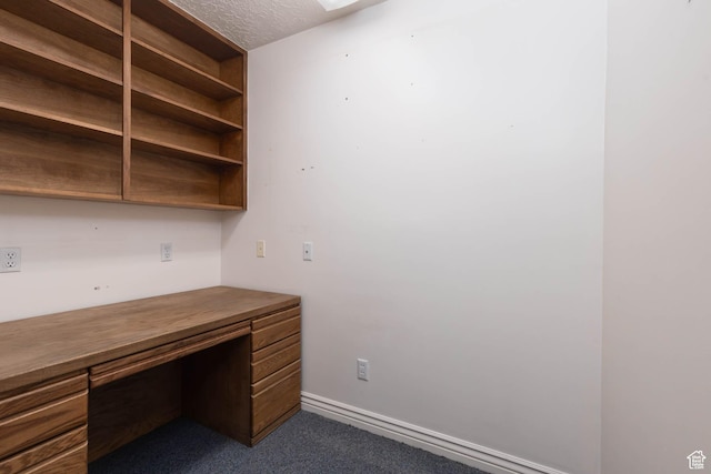 889 Upland Dr, Richfield, UT 84701 - unfurnished office with dark carpet, a textured ceiling, and built in desk