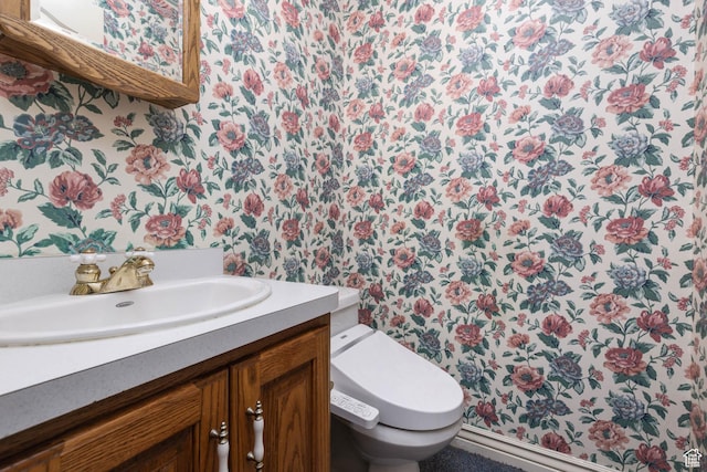 889 Upland Dr, Richfield, UT 84701 - half bathroom with toilet, wallpapered walls, and vanity