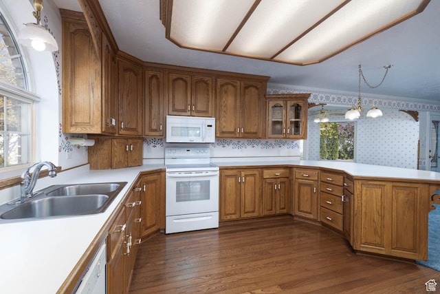 889 Upland Dr, Richfield, UT 84701 - kitchen with brown cabinets, a sink, light countertops, dark wood-style floors, and white appliances