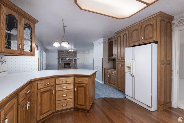 889 Upland Dr, Richfield, UT 84701 - kitchen featuring brown cabinets, glass insert cabinets, white refrigerator with ice dispenser, dark wood-type flooring, and a peninsula