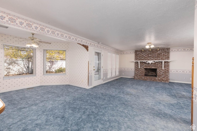889 Upland Dr, Richfield, UT 84701 - unfurnished living room featuring a fireplace, ceiling fan, a textured ceiling, wallpapered walls, and carpet floors