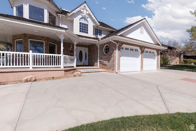 889 Upland Dr, Richfield, UT 84701 - view of front of home featuring concrete driveway, a porch, brick siding, and a garage