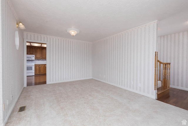 889 Upland Dr, Richfield, UT 84701 - unfurnished living room featuring carpet, visible vents, and wallpapered walls