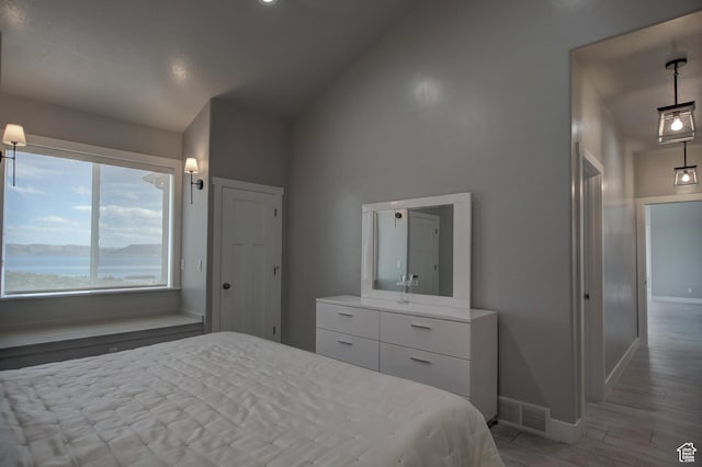 728 Loveland Ln, Fish Haven, ID 83287 - bedroom featuring baseboards, high vaulted ceiling, wood finished floors, and visible vents
