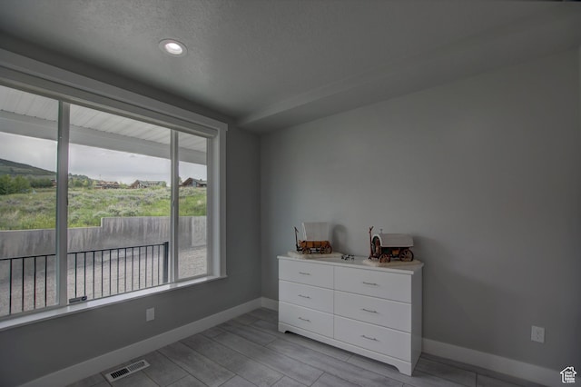 728 Loveland Ln, Fish Haven, ID 83287 - bedroom featuring a textured ceiling, visible vents, wood finish floors, and baseboards