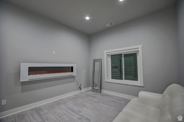 728 Loveland Ln, Fish Haven, ID 83287 - interior space with recessed lighting, wood finished floors, a glass covered fireplace, baseboards, and visible vents