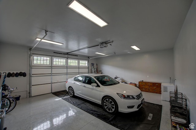 728 Loveland Ln, Fish Haven, ID 83287 - garage featuring a garage door opener and refrigerator