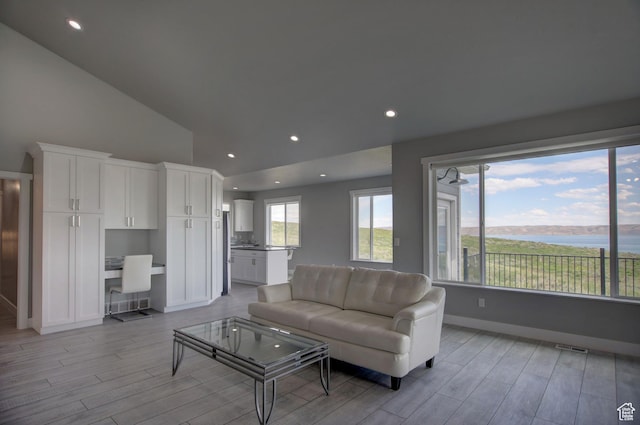728 Loveland Ln, Fish Haven, ID 83287 - living room with high vaulted ceiling, light wood finished floors, recessed lighting, and baseboards
