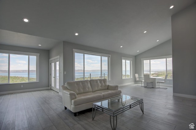 728 Loveland Ln, Fish Haven, ID 83287 - living room featuring recessed lighting, wood finished floors, a water view, baseboards, and lofted ceiling