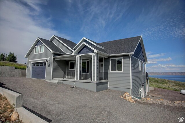 728 Loveland Ln, Fish Haven, ID 83287 - view of front of home with a garage, covered porch, and a shingled roof